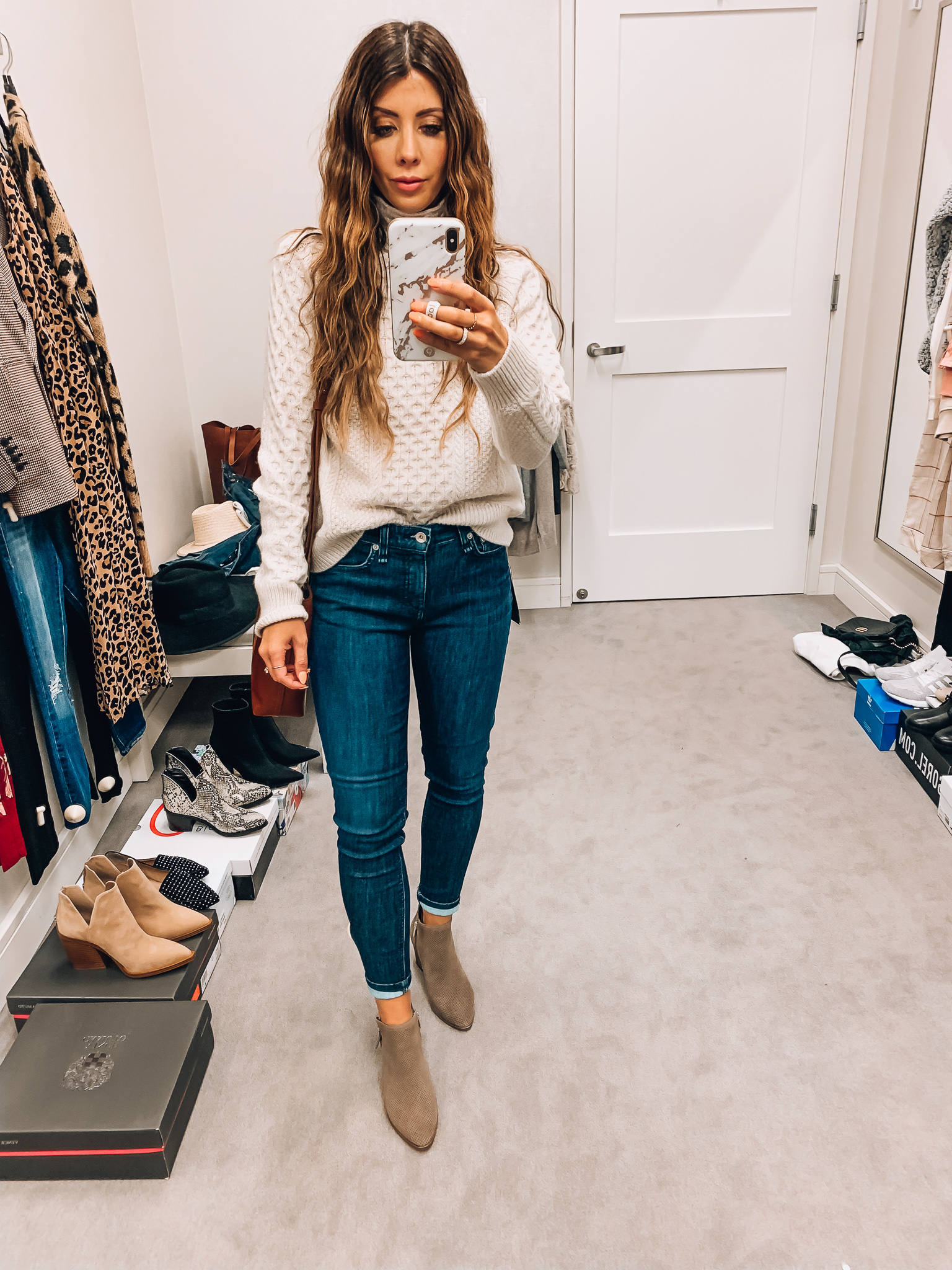 Nordstrom Anniversary Sale Early Access! by popular San Francisco fashion blog, The Girl in the Yellow Dress: image of a woman standing inside a Nordstrom dressing room wearing a Vince Mixed Cable Wool & Cashmere Blend Sweater, Rag and Bone Cate Ankle Skinny Jeans, Vince Camuto Nethera Perforated Bootie, and Madewell Small Transport Leather Crossbody Tote.