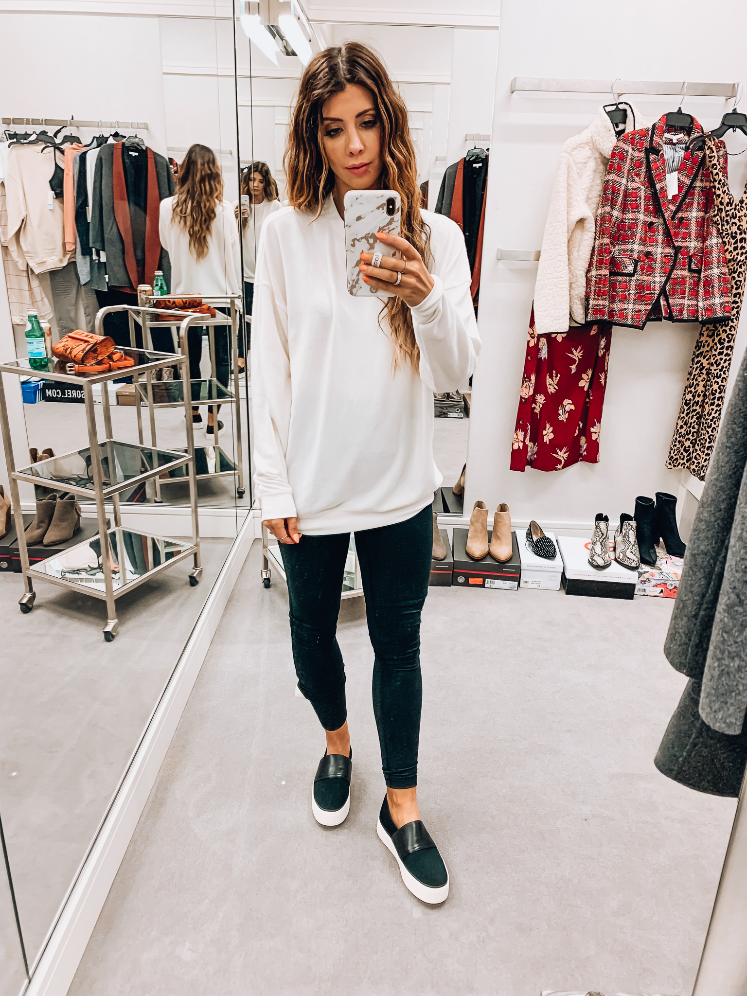 Nordstrom Anniversary Sale Early Access! by popular San Francisco fashion blog, The Girl in the Yellow Dress: image of a woman standing inside a Nordstrom dressing room wearing Zella Live In High Waist Leggings, ALO Soho Crewneck Pullover, and Vince Ward Knit Slip-On Sneaker.