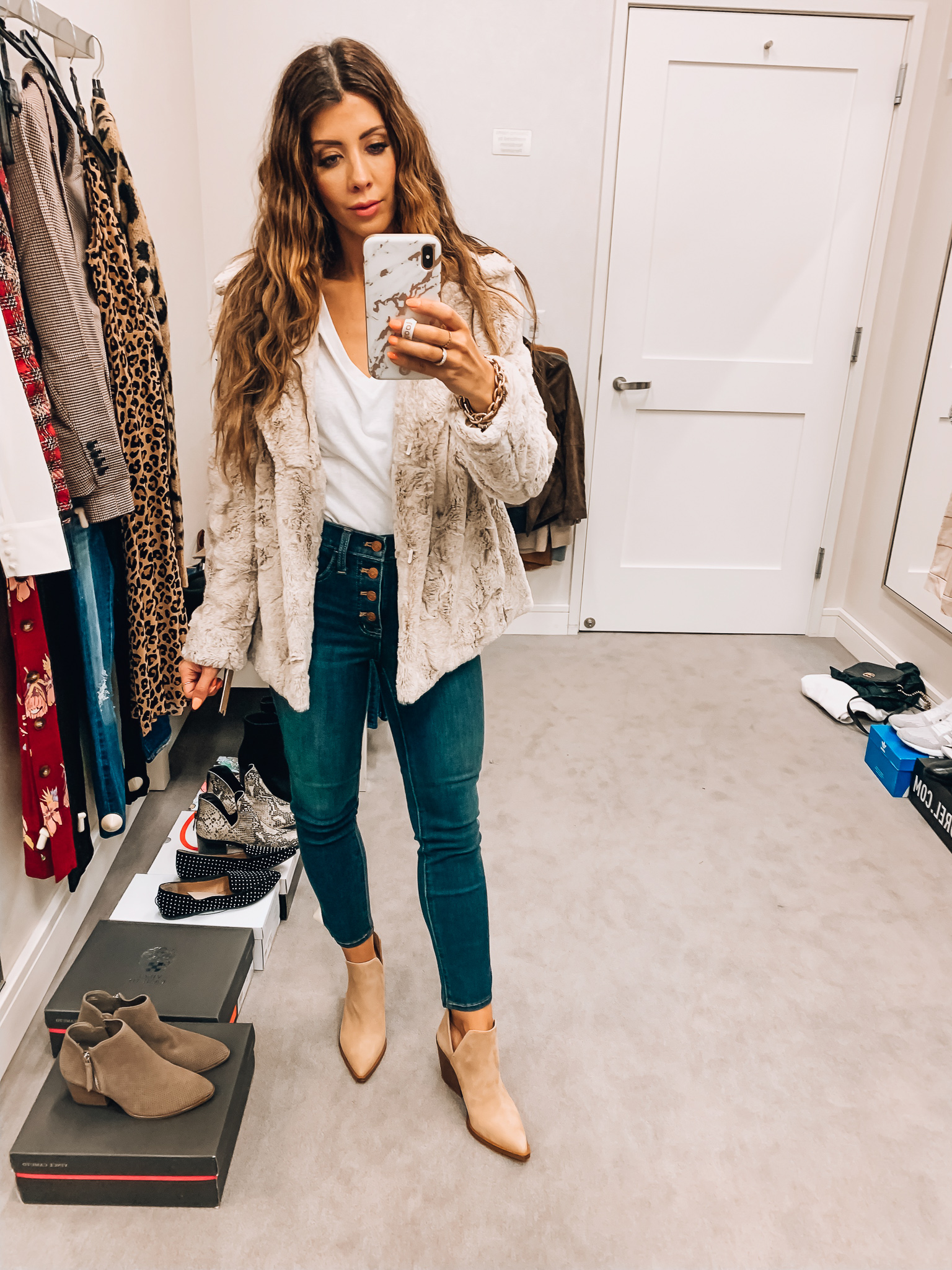 Nordstrom Anniversary Sale Early Access! by popular San Francisco fashion blog, The Girl in the Yellow Dress: image of a woman standing inside a Nordstrom dressing room wearing Vince Camuto Gigietta Bootie, BP. V-Neck Tee, Madewell 10-Inch High Waist Skinny Jeans: Button Front Edition, Kenneth Cole New York Hooded Faux Fur Jacket.