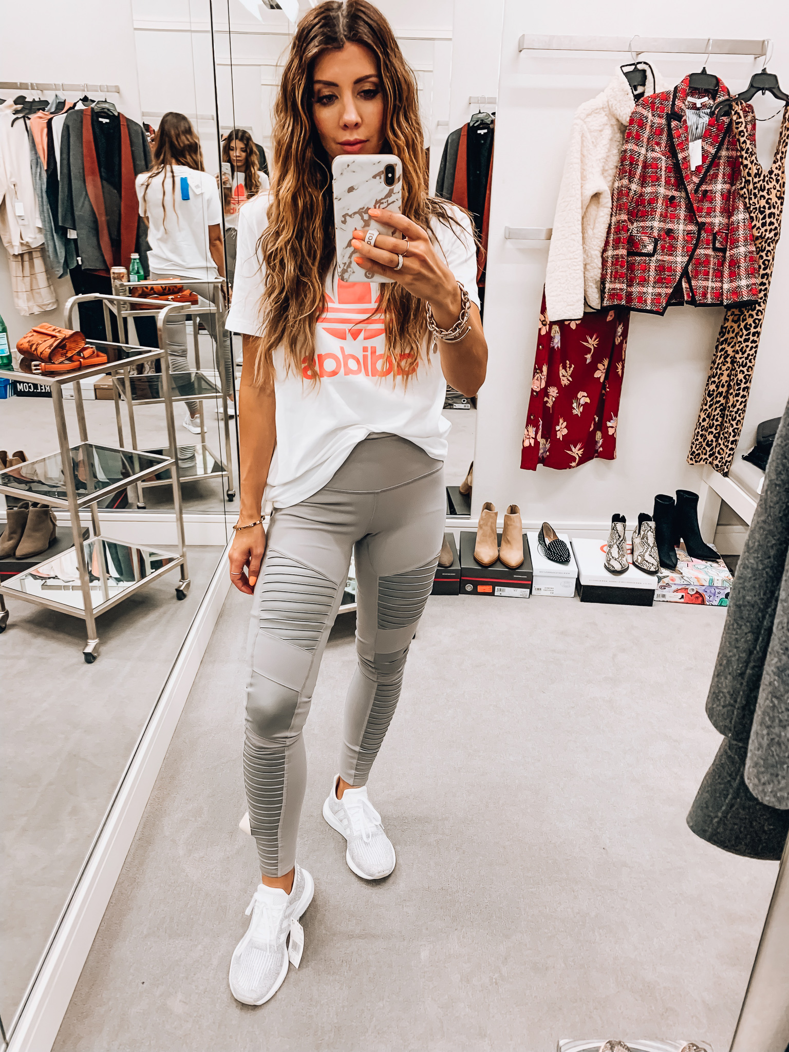 Nordstrom Anniversary Sale Early Access! by popular San Francisco fashion blog, The Girl in the Yellow Dress: image of a woman standing inside a Nordstrom dressing room wearing ALO High Waist Moto Leggings, Adidas Swift Run Sneaker, and adidas Trefoil Tee.