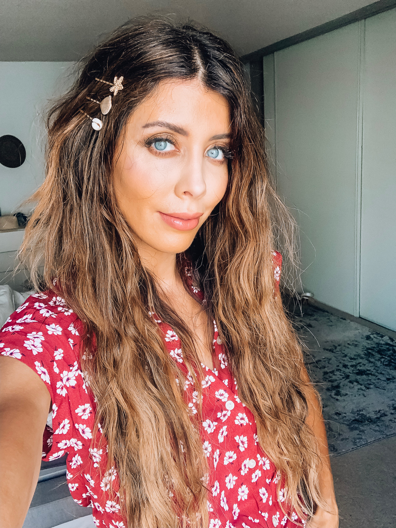 How to Use a Hair Waver + Styling Tips by popular San Francisco beauty blog, The Girl in the Yellow Dress: image of a woman with a wave hairstyle and wearing a red and white floral dress and a gold starfish and seashell hair clips.