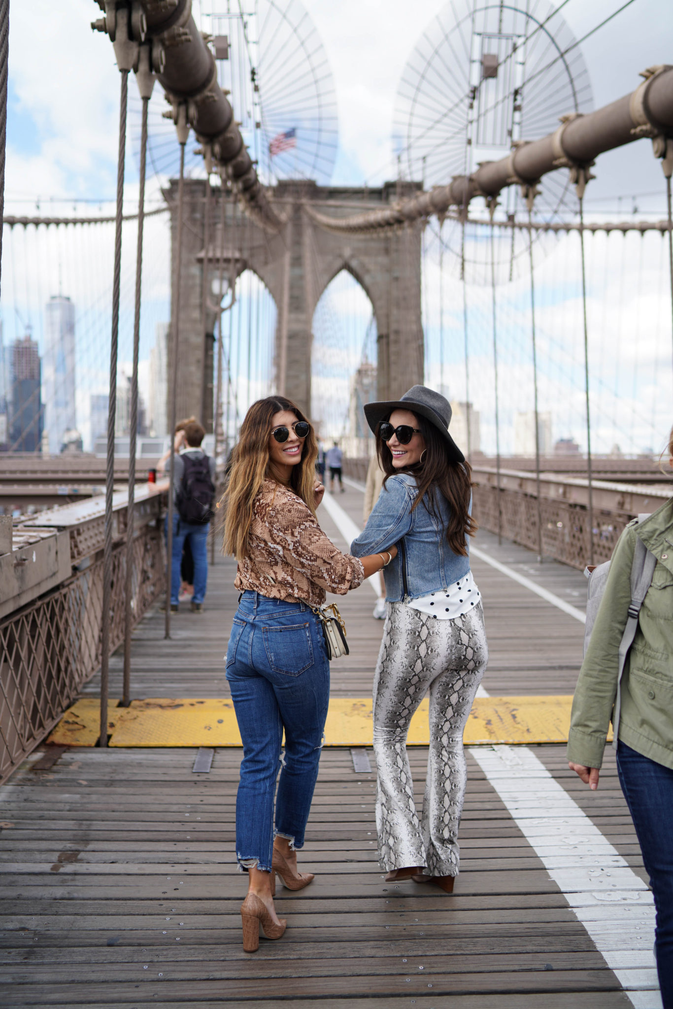 All Things Snakeskin Print by popular San Francisco fashion blog, The Girl in the Yellow Dress: image of a woman standing on the Brooklyn Bridge and wearing a H&M Long-sleeved Blouse, Abercrombie and Fitch Curve Love Ultra High Rise Ankle Straight Jeans, Nordstrom Steve Madden Prance Pump, Neiman Marcus Chloe Nile Small Bracelet Crossbody Bag, and Nordstrom Ray-Ban Icons 53mm Retro Sunglasses.