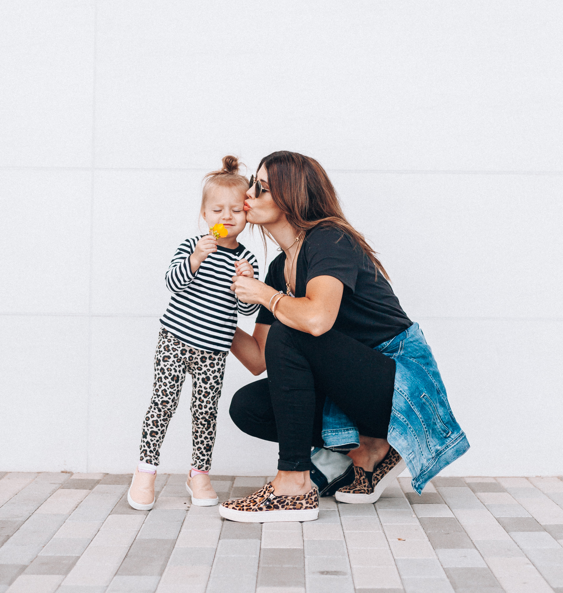 Casual Fall Outfits You'll Wear on Repeat by popular San Francisco fashion blog, The Girl in the Yellow Dress: image of a woman outside next to her daughter who is wearing a Toddler Toddler Girls' Long Sleeve Striped T-Shirt - Cat & Jack and Freshly picked Hazelnut Slip-On Sneakers, while the woman is wearing a BP V-Neck Tee, Topshop Jamie High Waist Black Jeans, DR. SCHOLL'S NO CHILL PLATFORM SLIP-ON SNEAKER, Evereve Ag Mya Denim Jacket, and Icons 53mm Retro Sunglasses RAY-BAN. 