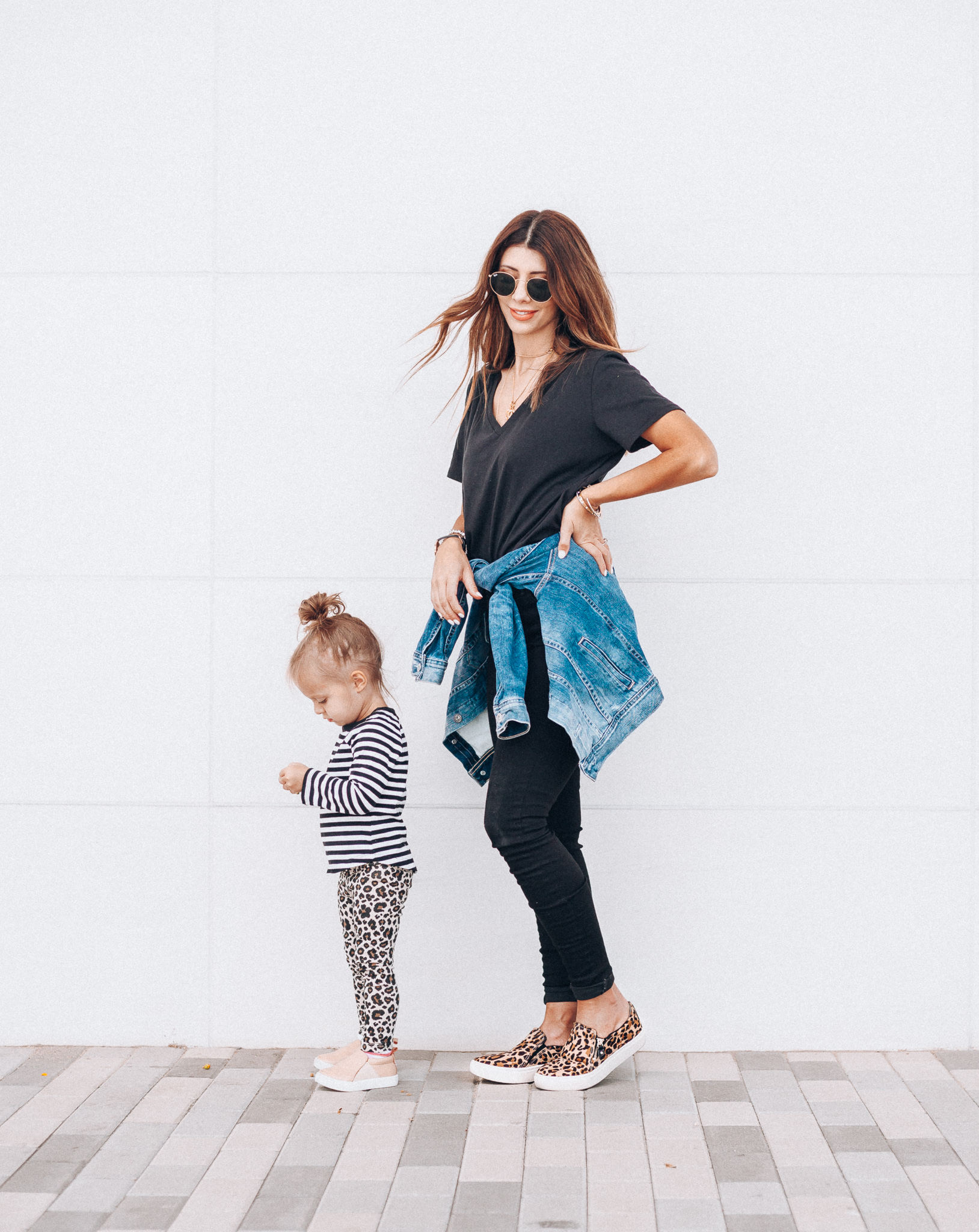 Casual Fall Outfits You'll Wear on Repeat by popular San Francisco fashion blog, The Girl in the Yellow Dress: image of a woman outside next to her daughter who is wearing a Toddler Toddler Girls' Long Sleeve Striped T-Shirt - Cat & Jack and Freshly picked Hazelnut Slip-On Sneakers, while the woman is wearing a BP V-Neck Tee, Topshop Jamie High Waist Black Jeans, DR. SCHOLL'S NO CHILL PLATFORM SLIP-ON SNEAKER, Evereve Ag Mya Denim Jacket, and Icons 53mm Retro Sunglasses RAY-BAN. 