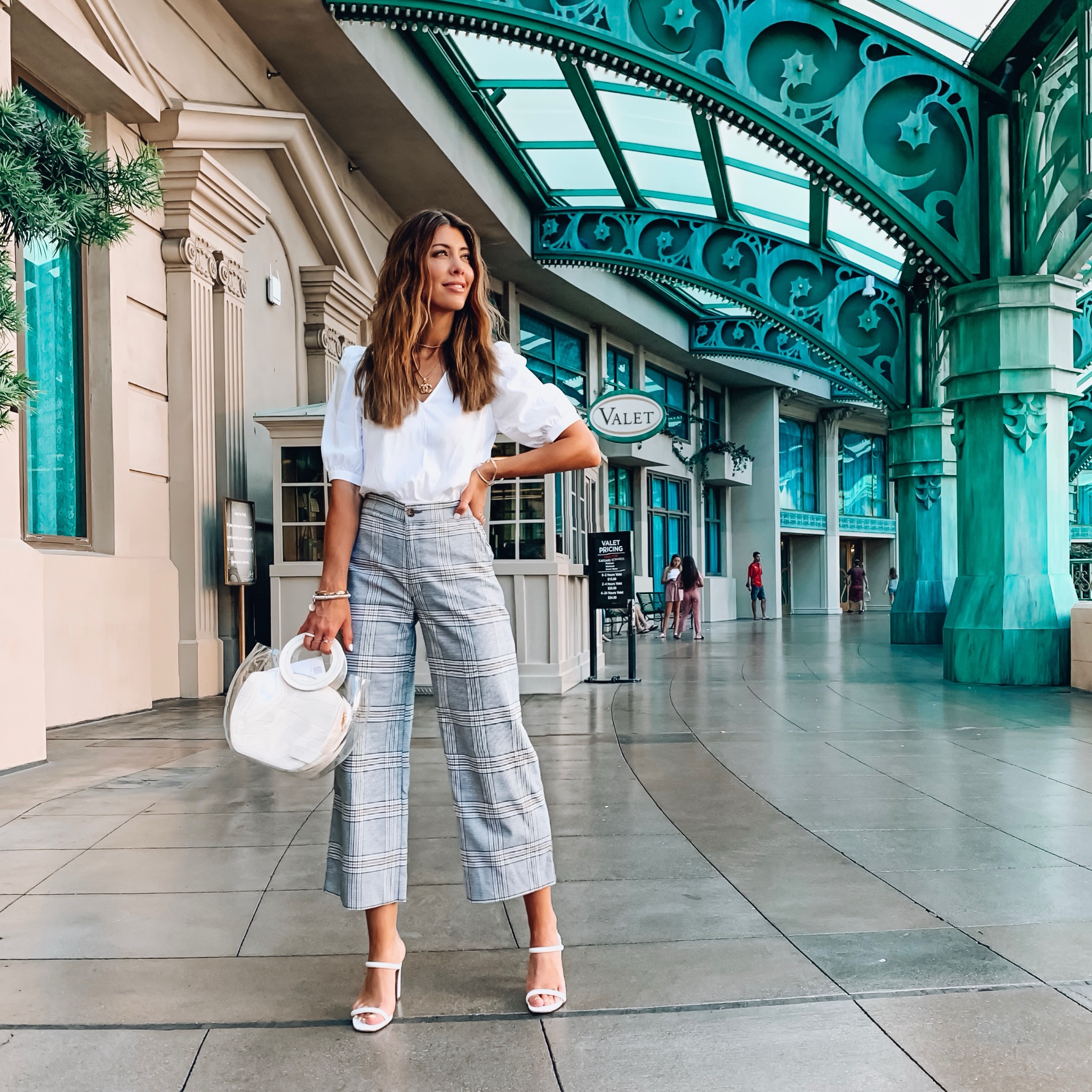 The Best Labor Day Weekend Sales and Deals featured by top US fashion blog, The Girl in the Yellow Dress: image of a woman standing inside a shopping center and wearing a Nordstrom Top Shop Puff Sleeve Crop Top, Abercrombie and Fitch CROPPED ULTRA HIGH RISE WIDE LEG PANTS, Steve Madden TAYA WHITE CROCODILE, and holding a Nordstrom Staud Frida Transparent Handbag.