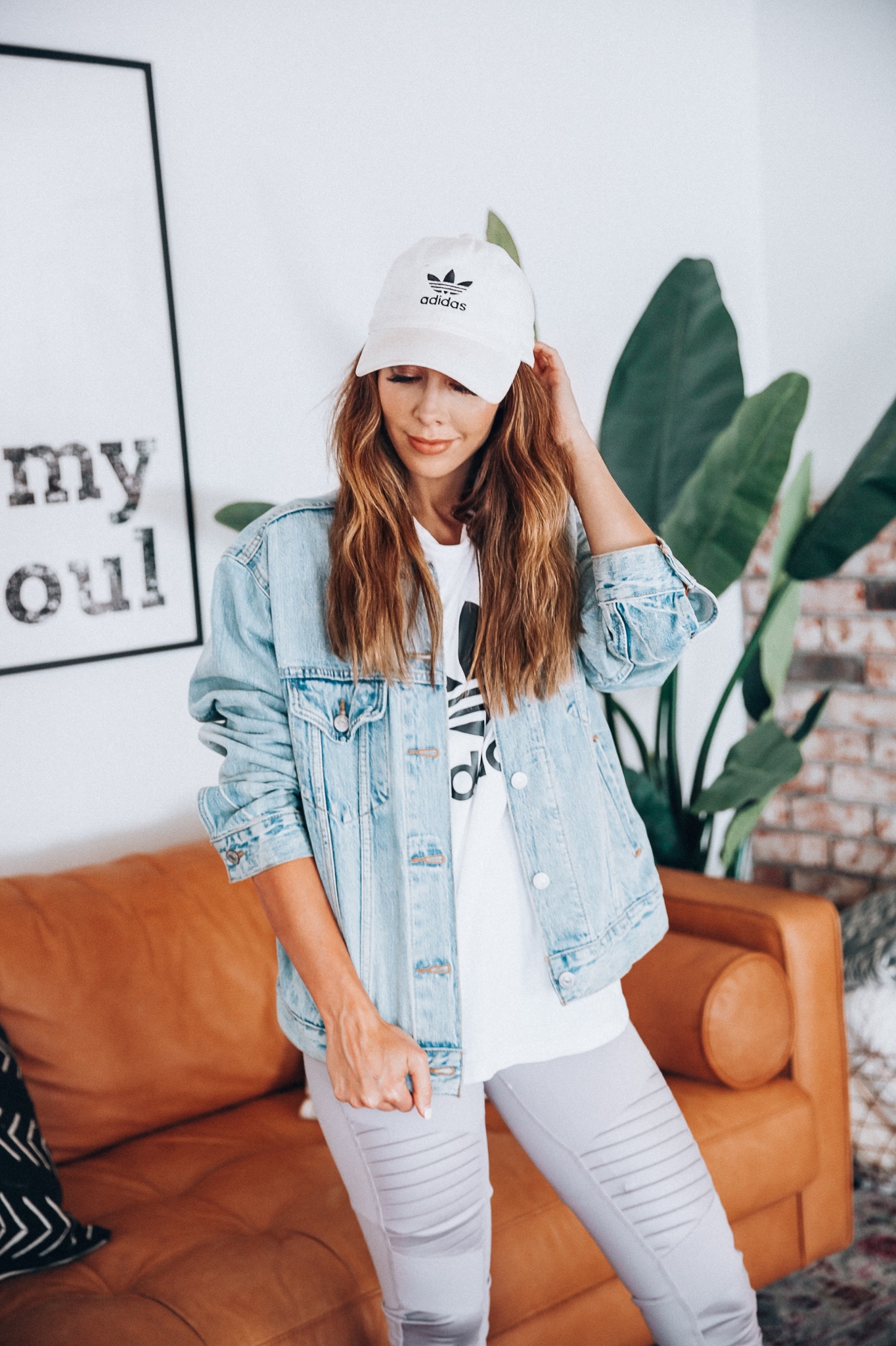 Go-To Fall Hats by popular San Francisco fashion blog, The Girl in the Yellow Dress: image of a woman wearing a Adidas Trefoil Tee, Levi's Ex-Boyfriend Trucker Jacket, Alo High Waist Moto Leggings, and Adidas baseball hat.