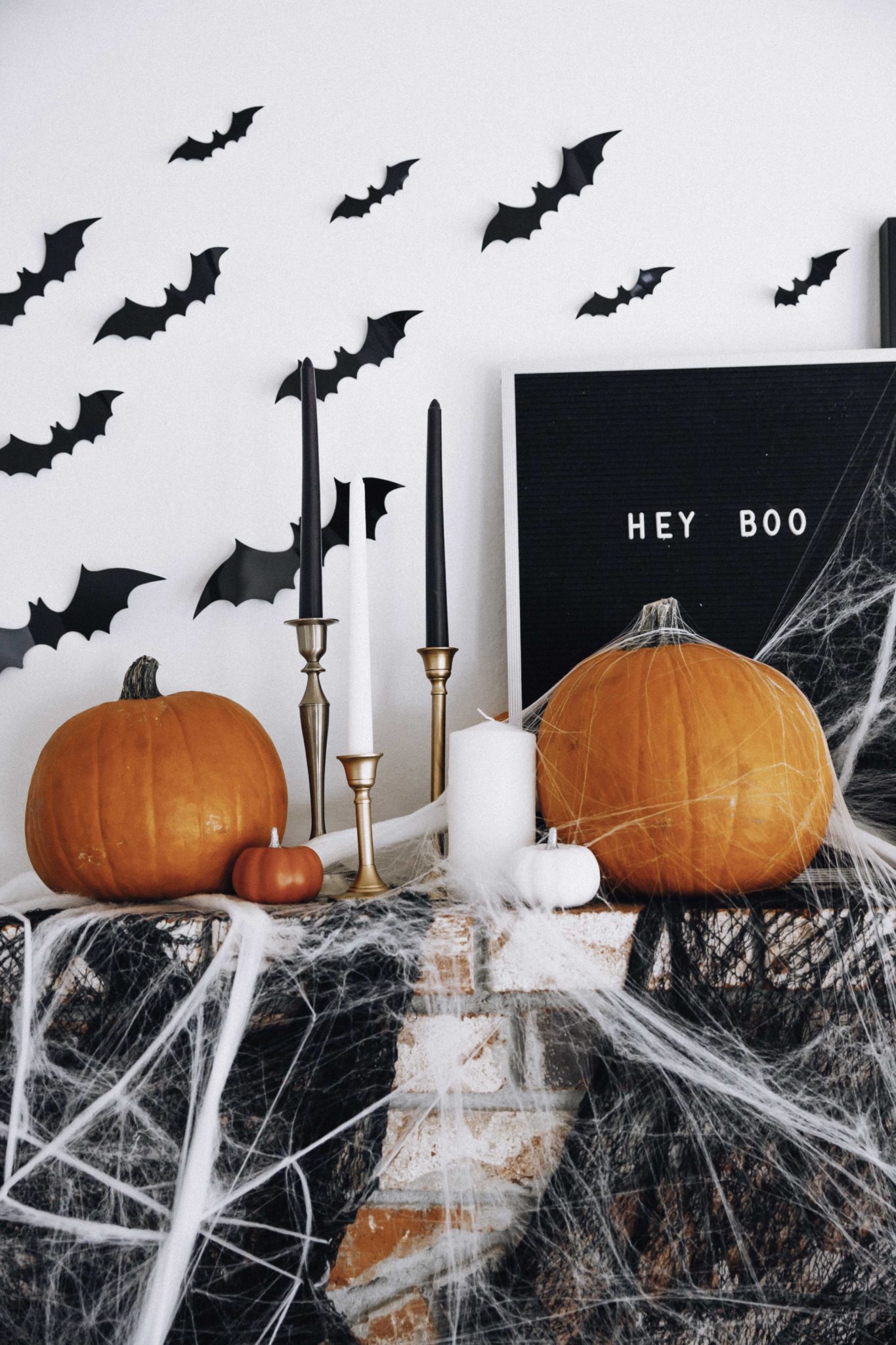 Halloween Mantel Decor + FREE Halloween Printable! by popular San Francisco lifestyle blog, The Girl in the Yellow Dress: image of fireplace mantel decorated with Target Halloween decor, pumpkins, and Amazon 3D bats.