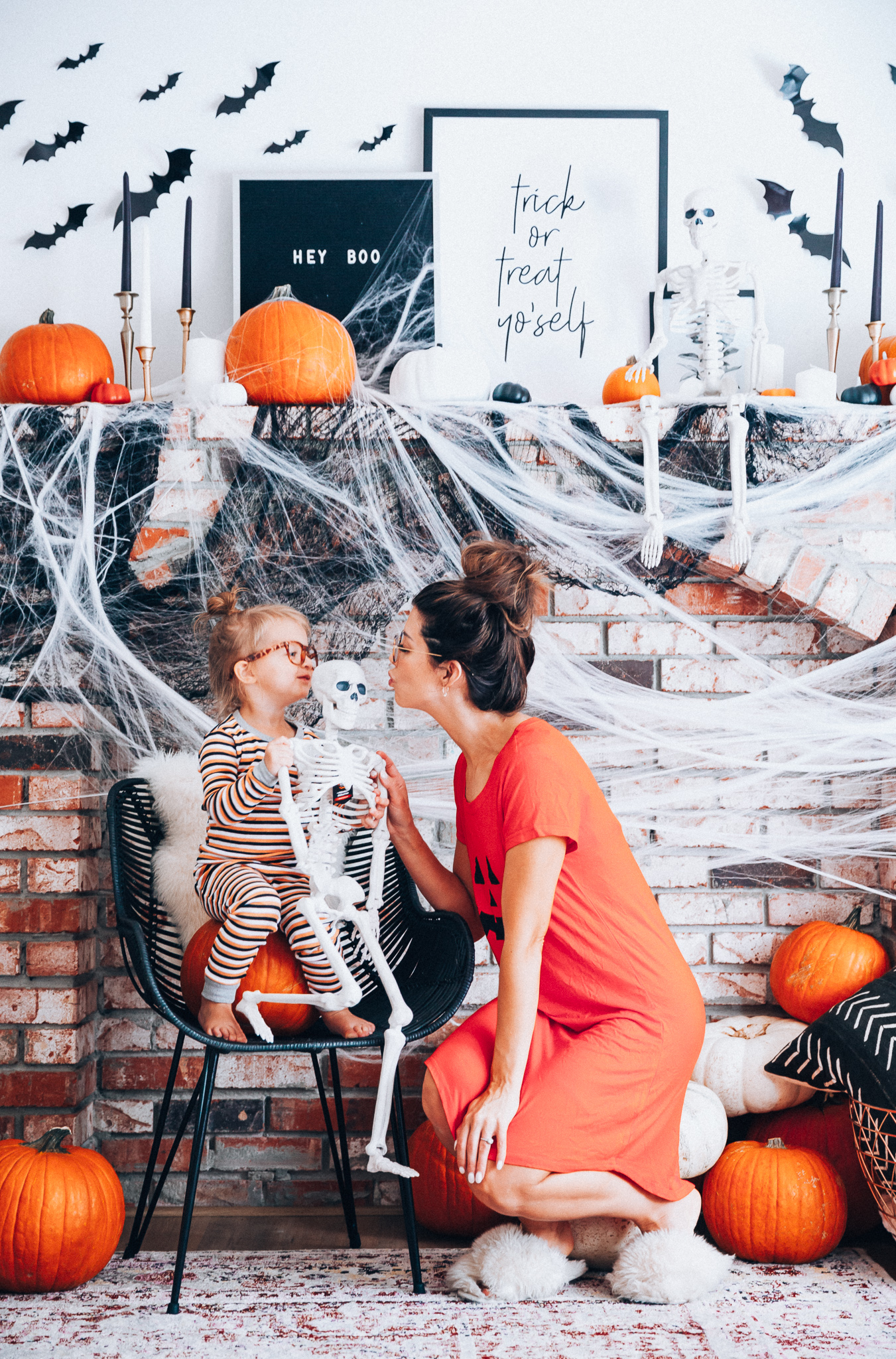 Halloween Mantel Decor + FREE Halloween Printable! by popular San Francisco lifestyle blog, The Girl in the Yellow Dress: image of woman and her young daughter sitting in front a their mantel decorated with Target Halloween decor and Amazon 3D bats and wearing Amazon Burt's Bees Baby Baby Pajamas, Tee and Pant 2-Piece PJ Set, Amazon Seekingtag Children Stylish Cute Glasses Frame Without Lenses, Amazon Hotouch Sleepwear Women's Nightgown Cotton Sleep Shirt, Eye Buy Direct FORTUNE Rectangle Tortoise Eyeglasses, and Nordstrom Patricia Green Mt. Hood Genuine Shearling Slipper.