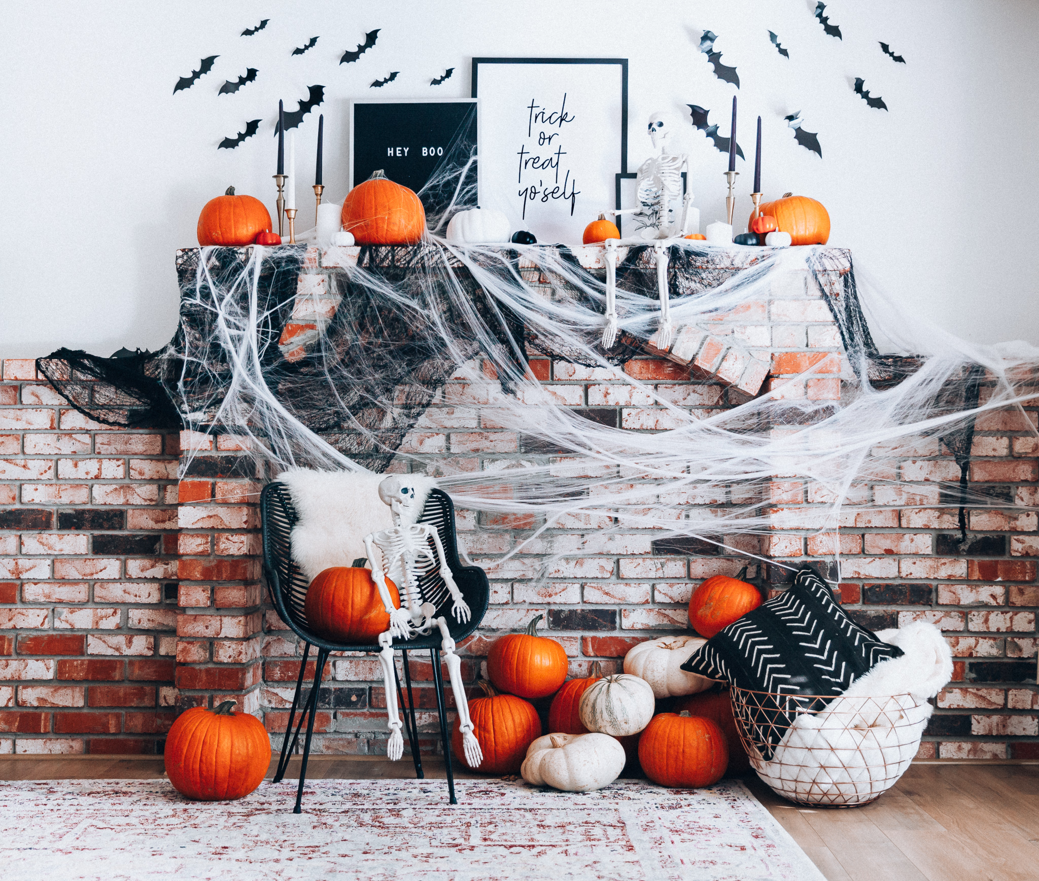 Halloween Mantel Decor + FREE Halloween Printable! by popular San Francisco lifestyle blog, The Girl in the Yellow Dress: image of fireplace mantel decorated with Target Halloween decor, pumpkins, and Amazon 3D bats.