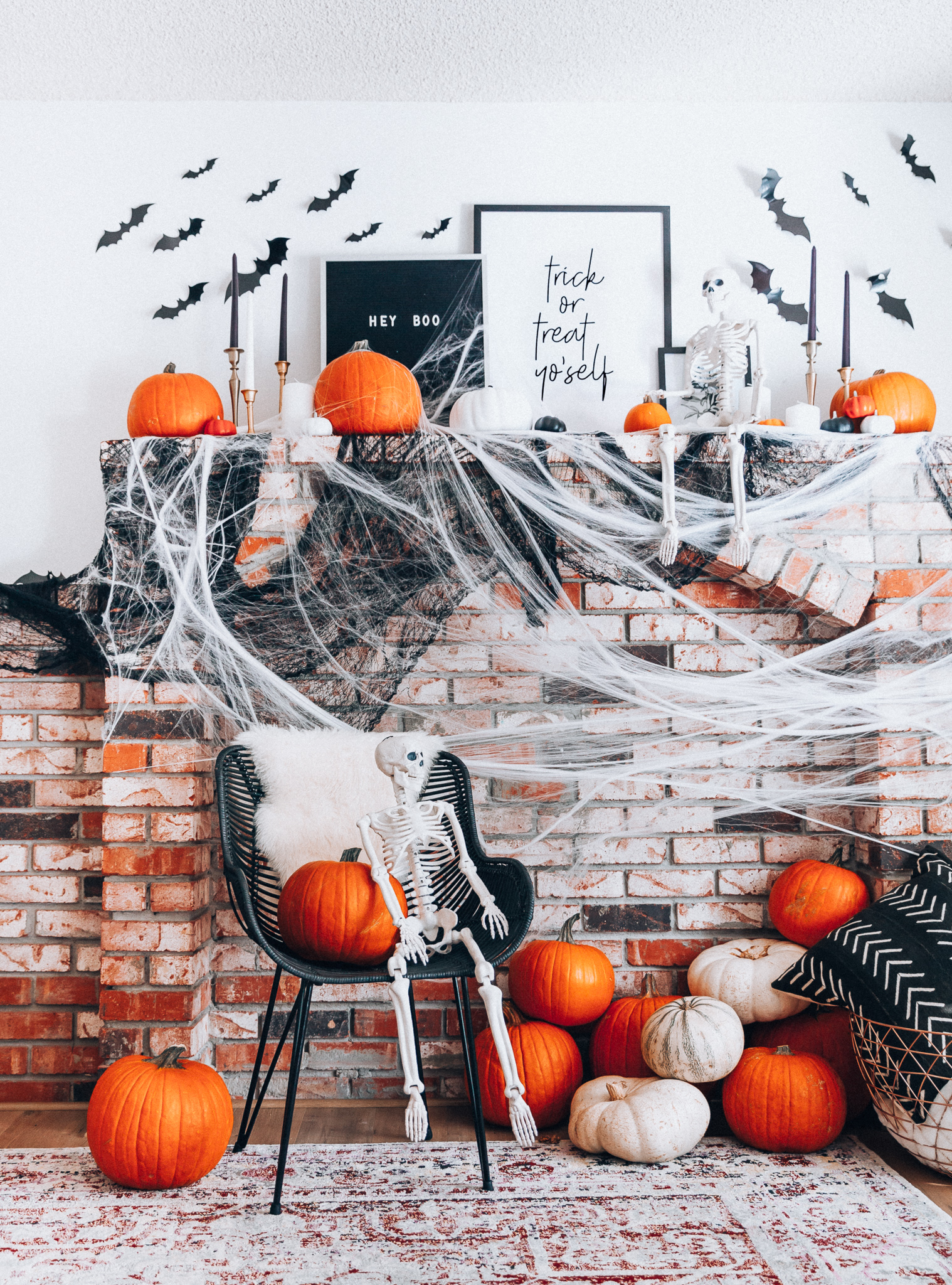 Halloween Mantel Decor + FREE Halloween Printable! by popular San Francisco lifestyle blog, The Girl in the Yellow Dress: image of fireplace mantel decorated with Target Halloween decor, pumpkins, and Amazon 3D bats.