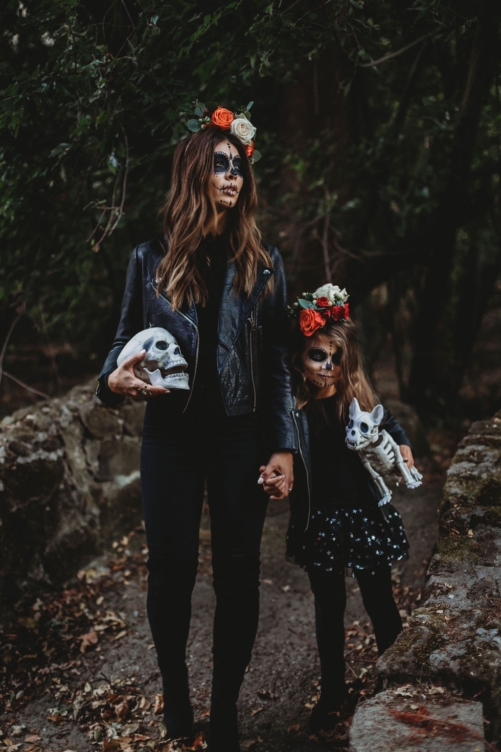 Halloween Sugar Skull Makeup by popular San Francisco beauty blog, The Girl in the Yellow Dress: image of a mom and daughter with Halloween sugar skull makeup and wearing a Gap Toddler Faux-Leather Biker Jacket, Nordstrom Tucker + Tate 'Core' Leggings, Target Cat + Jack Toddler Girls' Unity Fashion Boots, Oldnavy Crew-Neck Long-Sleeve Tee for Toddler Girls, DOMIRY Tulle Tutu Skirt for Little Girls Layered Sparkle Star Princess Ballet Dance Dress Puffy Skirt, Nordstrom BLANKNYC Tonal Star Faux Leather Moto Jacket, Nordstrom Steve Madden Jacey Over the Knee Boot, Nordstrom TopShop Joni High Waist Jeans, and ShopBop WAYF Berklin Lace Top and holding a Target Hide and Eek! Boutique Chihuahua Skeleton Decorative Halloween Prop.