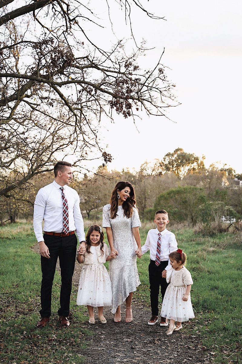 Merry Christmas Wishes 2019 by popular San Francisco life and style blog, The Girl in the Yellow Dress: image of a family standing together outside in a grassy field and wearing Nordstrom Sam Edelman Yaro Ankle Strap Sandals, H&M Earrings with Beads, Express Slim Solid Wrinkle-Resistant Performance Dress Shirt, Nordstrom Topman Skinny Fit Textured Dress Pants, Nordstrom Magnanni 'Lamont' Cap Toe Oxford, Nordstrom Ted Baker London Plaid Silk Tie, H&M Sequined Tulle Dress, and Amazon THEE BRON Girl's Toddler/Little Kid Ballet Mary Jane Flat Shoes.