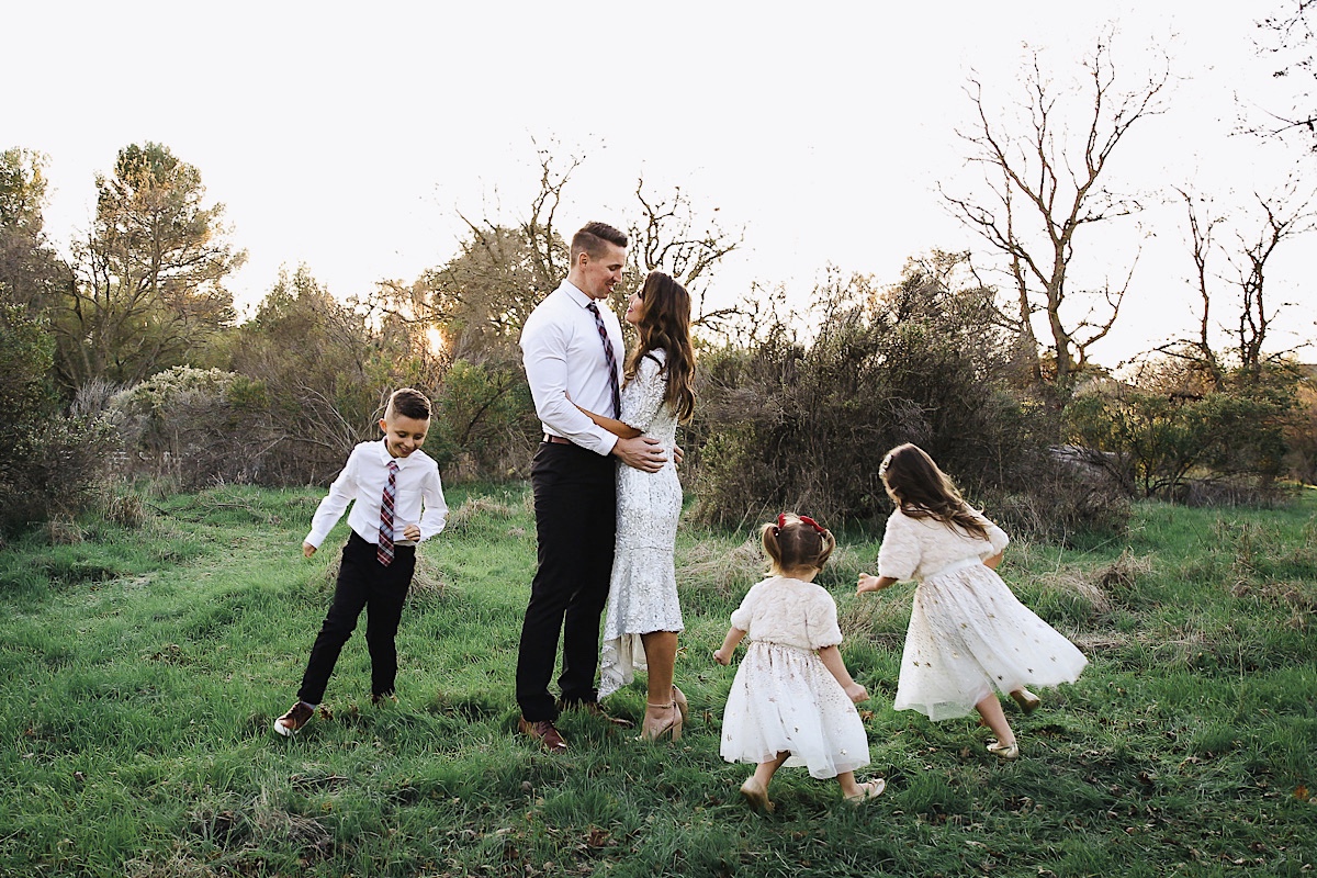 Merry Christmas Wishes 2019 by popular San Francisco life and style blog, The Girl in the Yellow Dress: image of a family standing together outside in a grassy field and wearing Nordstrom Sam Edelman Yaro Ankle Strap Sandals, H&M Earrings with Beads, Express Slim Solid Wrinkle-Resistant Performance Dress Shirt, Nordstrom Topman Skinny Fit Textured Dress Pants, Nordstrom Magnanni 'Lamont' Cap Toe Oxford, Nordstrom Ted Baker London Plaid Silk Tie, H&M Sequined Tulle Dress, and Amazon THEE BRON Girl's Toddler/Little Kid Ballet Mary Jane Flat Shoes.