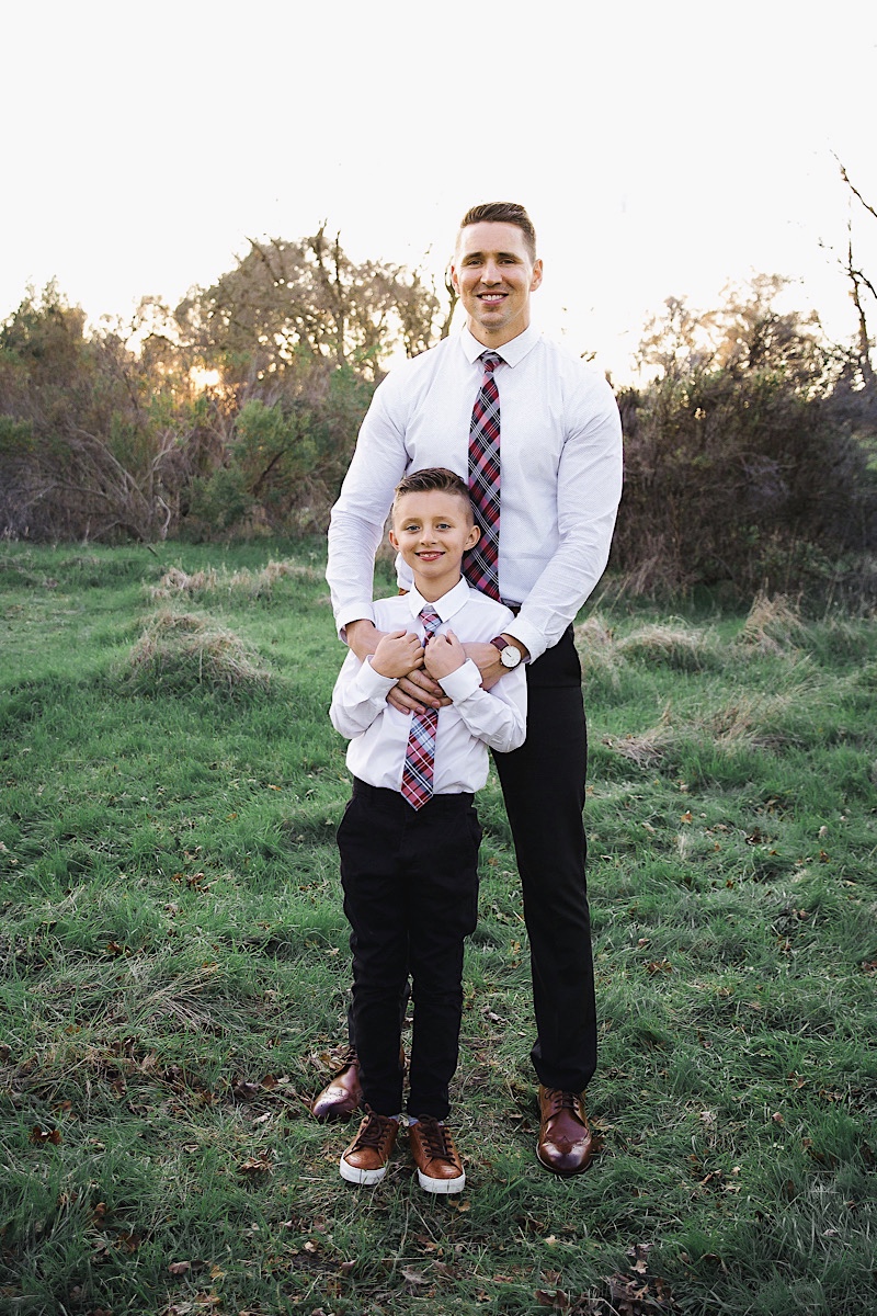 Merry Christmas Wishes 2019 by popular San Francisco life and style blog, The Girl in the Yellow Dress: image of a father and son standing together outside in a grassy field and wearing Express Slim Solid Wrinkle-Resistant Performance Dress Shirt, Nordstrom Topman Skinny Fit Textured Dress Pants, Nordstrom Magnanni 'Lamont' Cap Toe Oxford, and Nordstrom Ted Baker London Plaid Silk Tie.