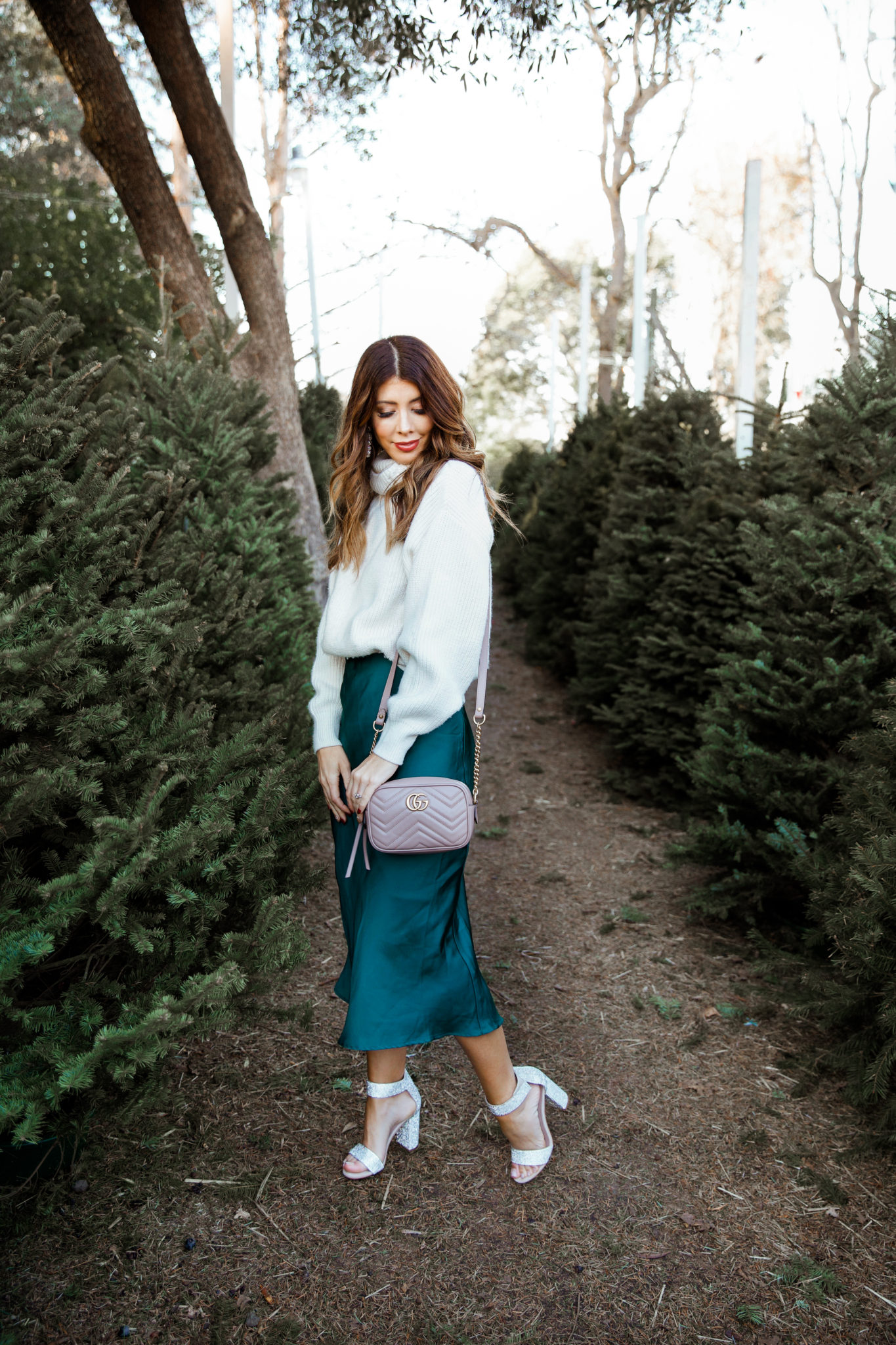 New Year's Eve Party Outfits by popular San Francisco fashion blog, The Girl in the Yellow Dress: image of a woman outside wearing Nordstrom Jeffrey Campbell Lindsay Sandals, Nordstrom Leith Satin Midi Skirt, and H&M Rib-knit Skirt.