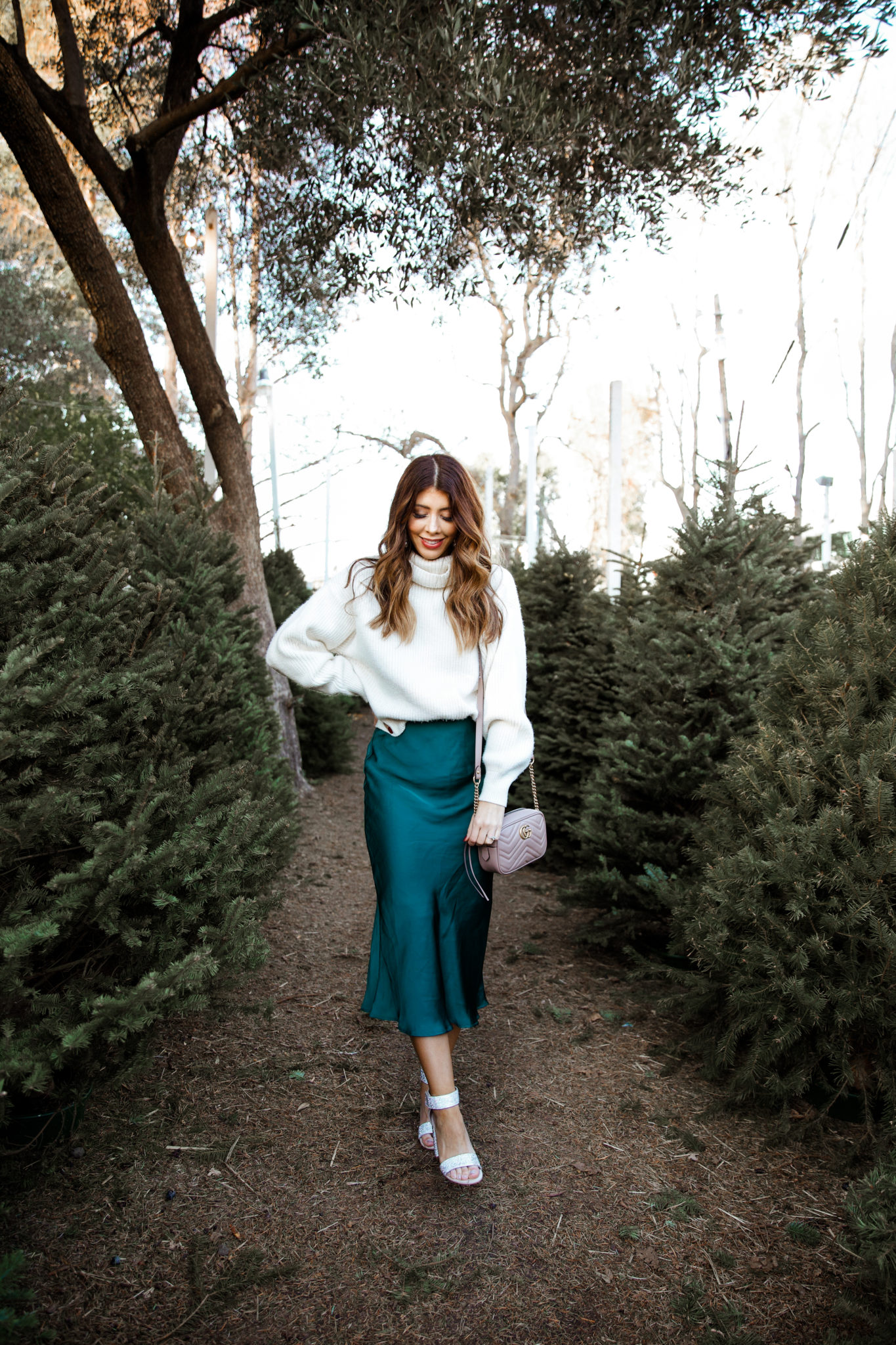 New Year's Eve Party Outfits by popular San Francisco fashion blog, The Girl in the Yellow Dress: image of a woman outside wearing Nordstrom Jeffrey Campbell Lindsay Sandals, Nordstrom Leith Satin Midi Skirt, and H&M Rib-knit Skirt.