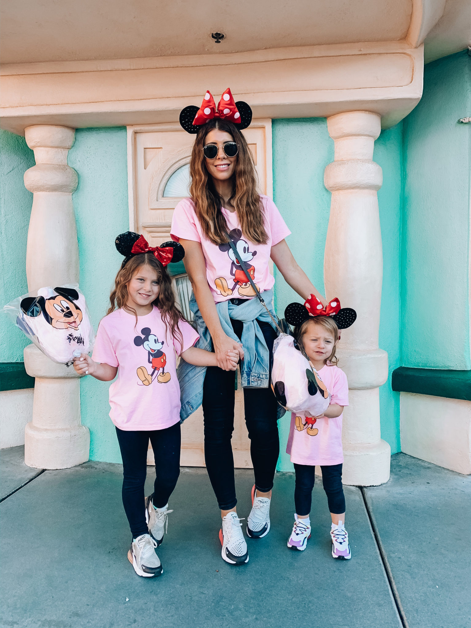 Disneyland Tips for Families! by popular San Francisco life and style blog, The Girl in the Yellow Dress: image of a family at Disneyland and wearing a Amazon Disney Classic Mickey Mouse T-Shirt, Nordstrom Jamie High Waist Black Jeans TOPSHOP, Gucci GG Marmont Matelassé Mini Bag, Levi's Original Trucker Jacket, Amazon Amazon Essentials Girls 3-Pack Leggings, Nike Air Max 270, and Nike Air Max 270 RT. 