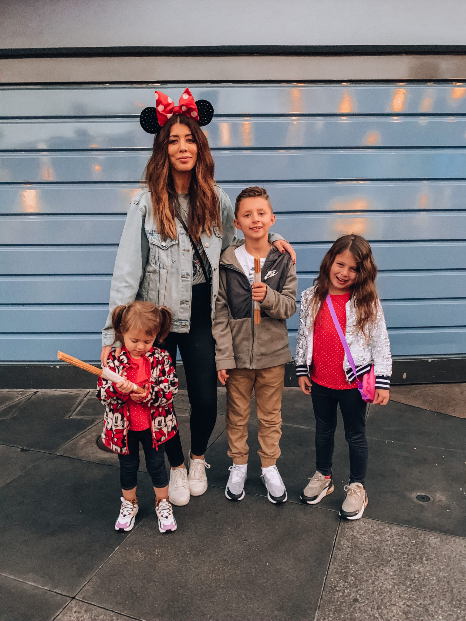 Disneyland Tips for Families! by popular San Francisco life and style blog, The Girl in the Yellow Dress: image of a family at Disneyland and wearing Nike Air Max 270 RT, Nike Air Max 270, H&M Puff-sleeved Jersey Bodysuit, American Eagle High Rise Mom Jeans, FitFlop RALLY Scallop Leather Sneakers, Disney Minnie Mouse Satin Polka Dot Bow Ear Headband, Gucci belt, Amazon adidas Originals Men's Trefoil Tee, Nike Sportswear Club Fleece, Amazon adidas Originals Boys' Kids Trefoil Tee, and Nordstrom Sports Jogger Pants ADIDAS.