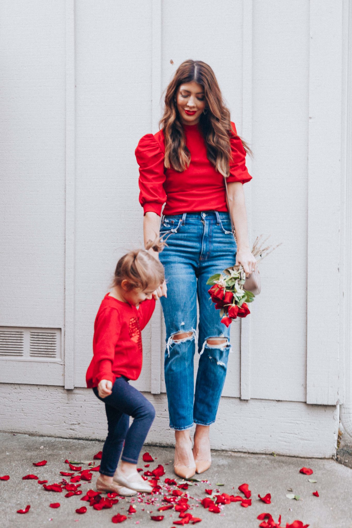 Mommy and Me Valentine's Day Outfits by popular San Francisco fashion blog, The Girl in the Yellow Dress: image of a mom and her daughter wearing an Amazon ROMWE Women's Summer Short Sleeve Mock Neck Casual Blouse Top, Abercrombie and Fitch High Rise Mom Jeans, Nordstrom Jaina Pump SAM EDELMAN, Nordstrom Matelassé Leather Shoulder Bag GUCCI, Amazon Carter's Valentines Day Red Heart Sweater with Sequins for Toddler Girls, Target Toddler Girls' Faux Denim Leggings, and Amazon THEE BRON Girl's Toddler/Little Kid Ballet Mary Jane Flat Shoes.