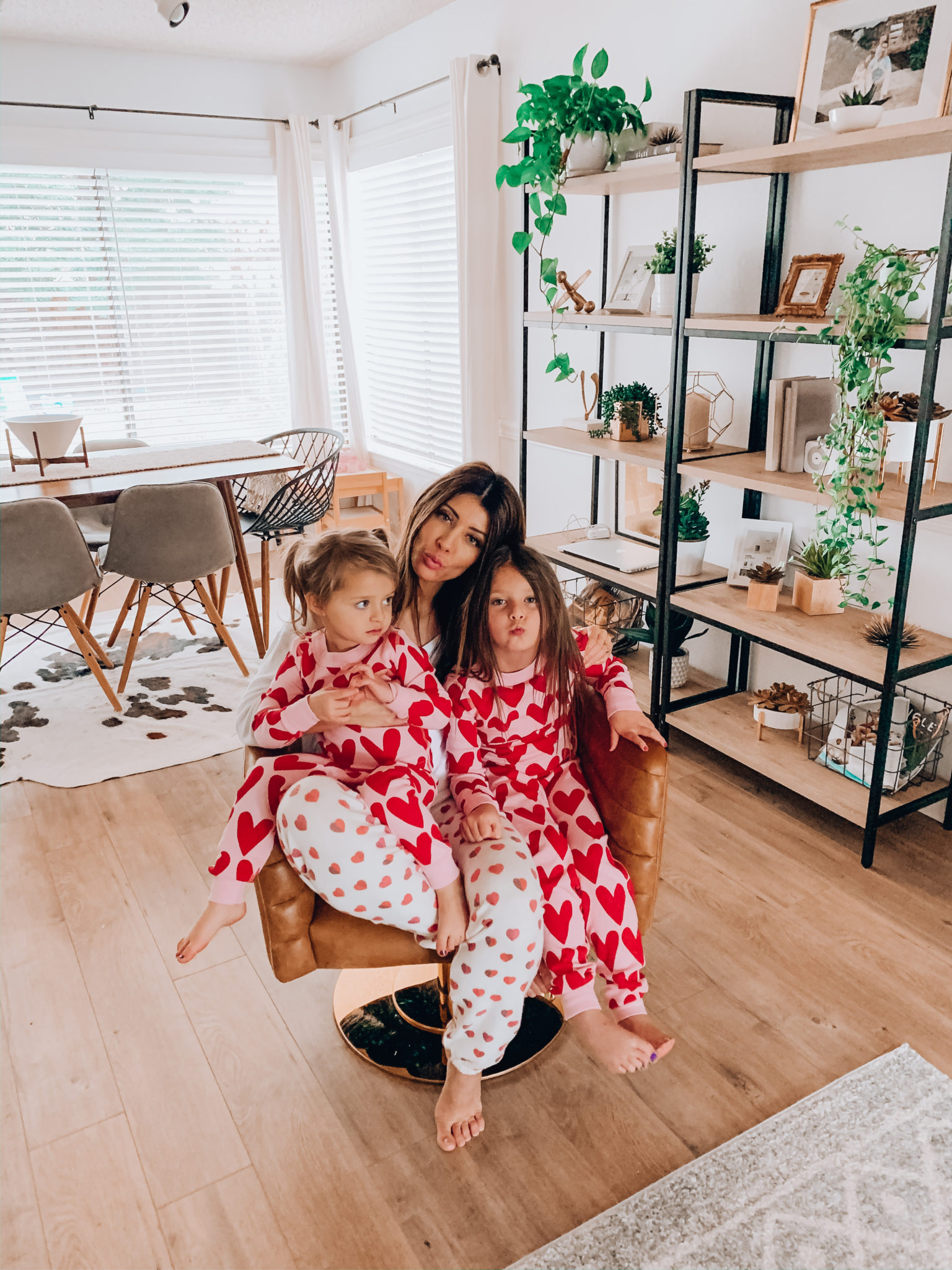 Mommy and Me Valentine's Day Outfits by popular San Francisco fashion blog, The Girl in the Yellow Dress: image of a woman and her two daughters wearing hear pajama sets. 