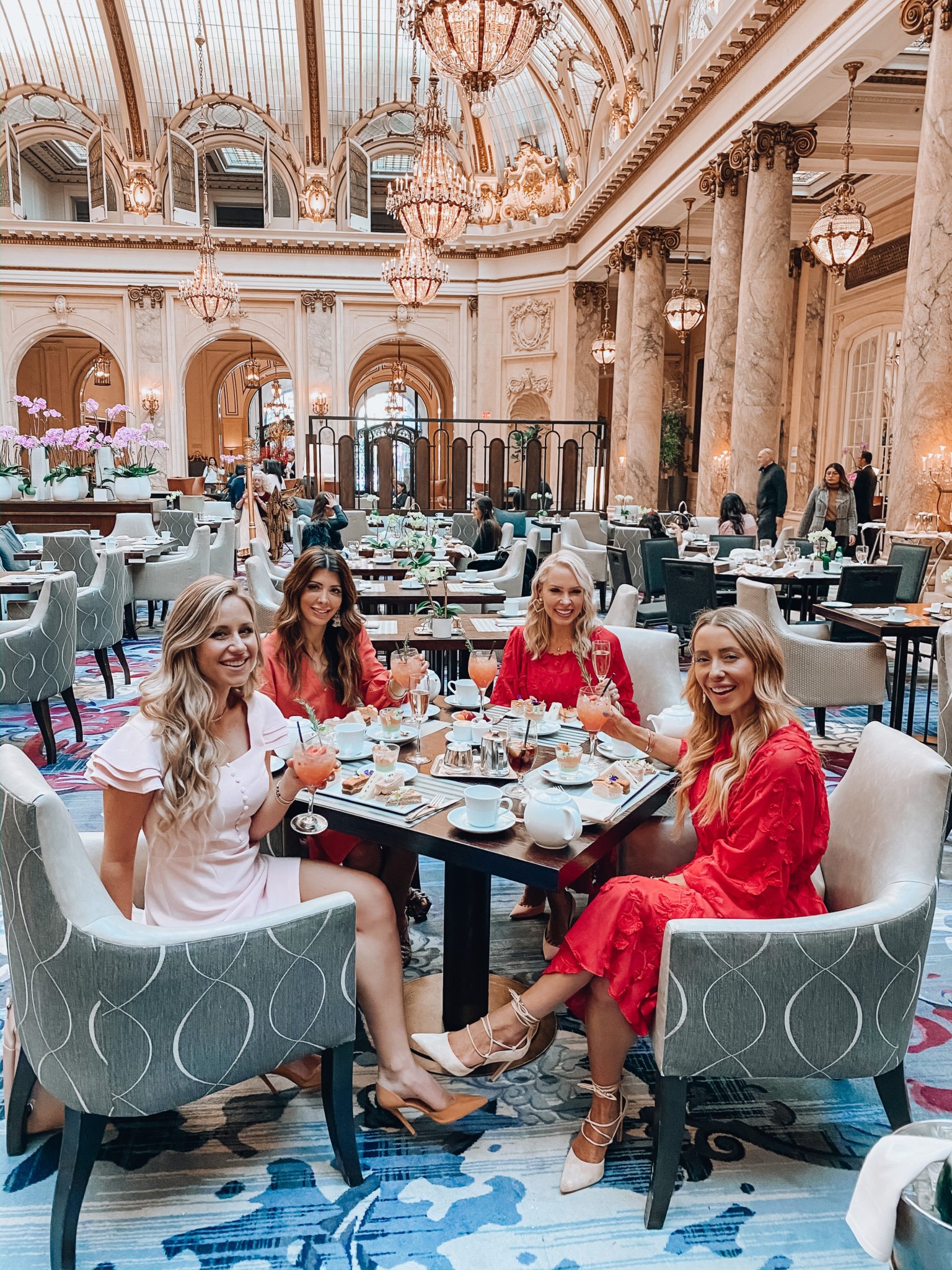 The Palace Hotel San Francisco by popular San Francisco blogger, The Girl in the Yellow Dress: image of 4 women standing together in the Palace Hotel San Francisco restaurant and wearing a Anthropologie Amber Tiered Tunic, Sam Edelman Daffodil Heel Sandal, Saks Fifth Avenue Gucci Marmont Matelasse mini purse, and Anthropologie Amal Textured Mini Dress.