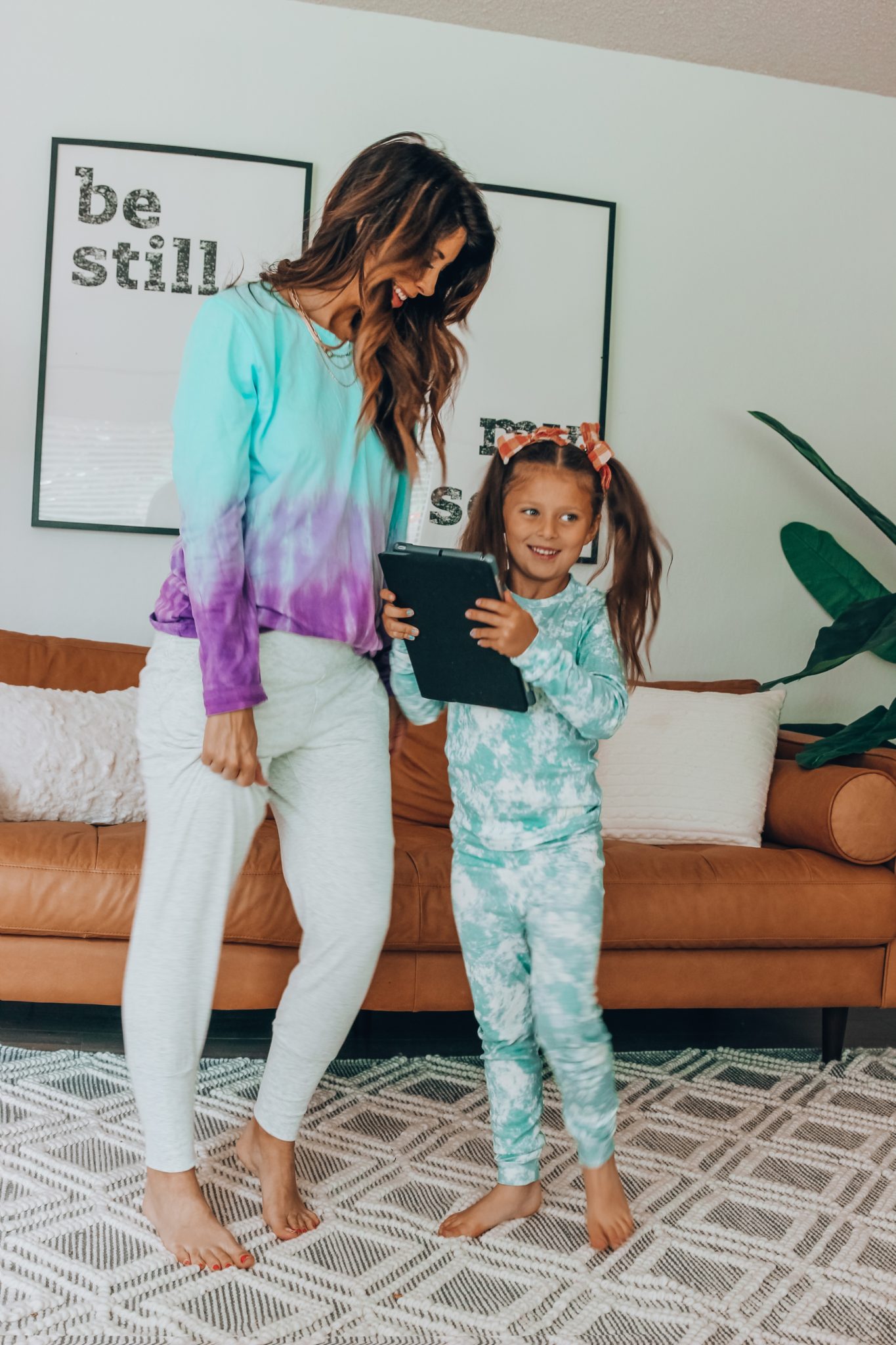 Messenger Kids Review by popular San Francisco lifestyle blog,The Girl in the Yellow Dress: image of a mom and her daughter standing together and holding a tablet. 